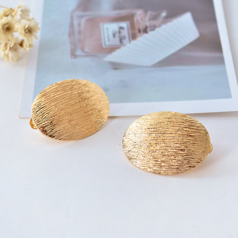 Clip on 1" gold textured oval button style earrings