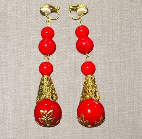 Clip on 2 3/4" long gold crown cutout and red dangle multi bead earrings