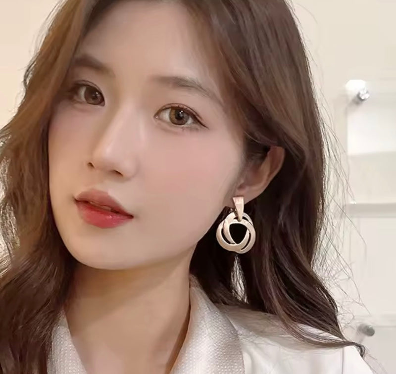 Clip on 1 3/4" matte gold swirl dangle earrings