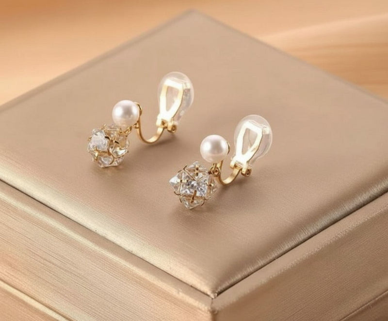 Clip on gold and pearl earrings with dangle clear stone ball