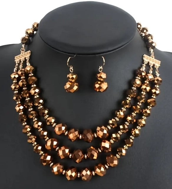 Pierced gold and brown shiny three strand necklace and earrings set