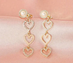 Clip on gold, pearl and fluorescent stone dangle three heart earrings