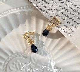 Clip on 1 1/4" gold cutout heart earrings with dangle black bead
