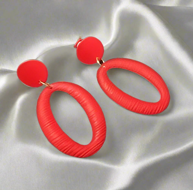Clip on 2 1/2" long red textured cutout lightweight hoop earrings
