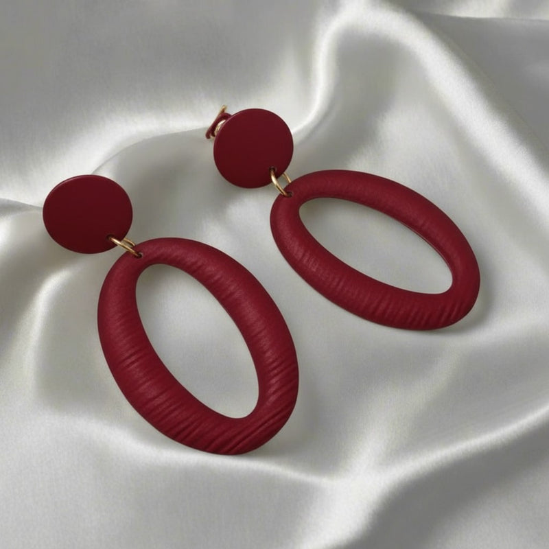 Clip on 2 1/2" long red textured cutout lightweight hoop earrings