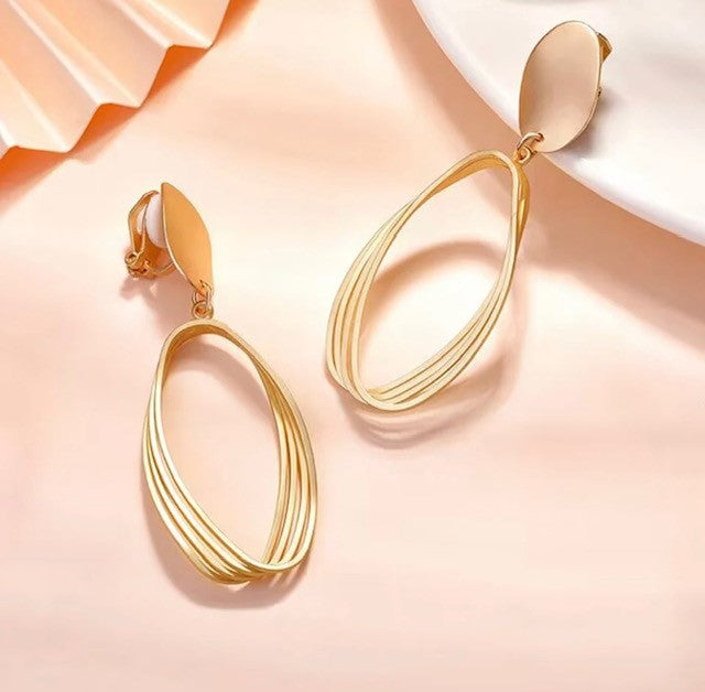 Classy 2 1/2" clip on lightweight shiny gold cutout dangle earrings