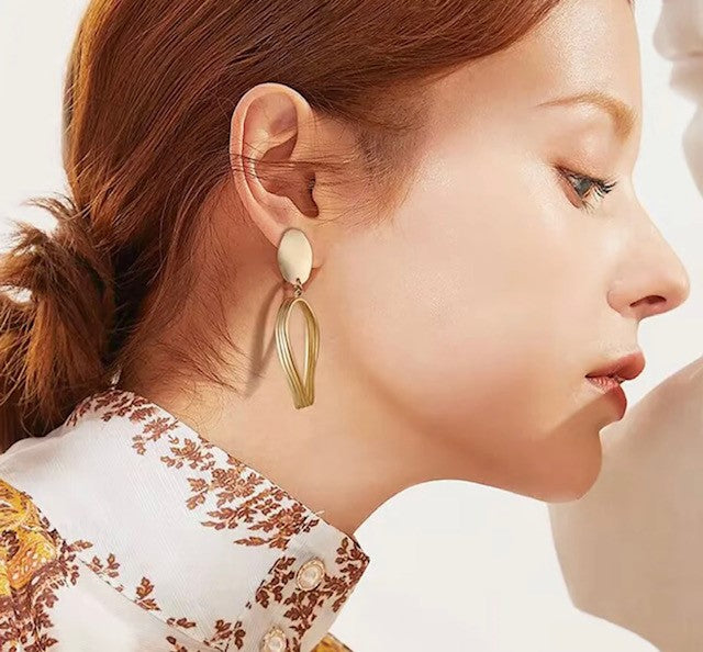 Classy 2 1/2" clip on lightweight shiny gold cutout dangle earrings