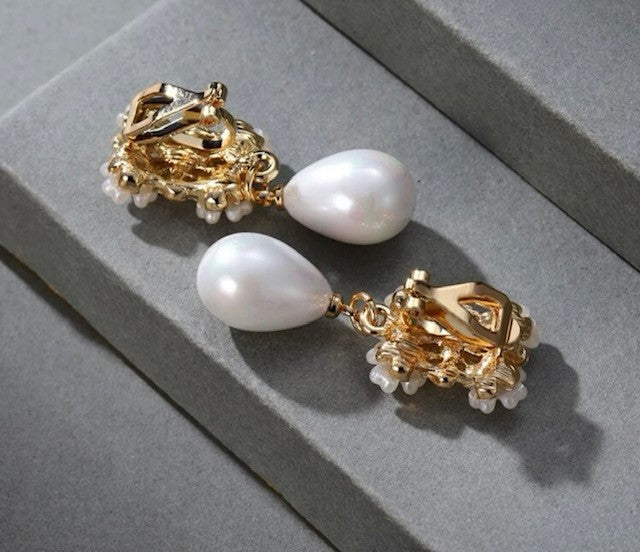 Clip on 1 1/2" gold white fluorescent flower earrings w/dangle bead