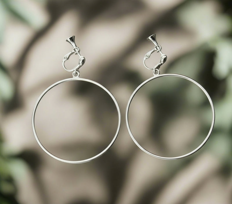 Clip on 3/4" gold and fluorescent white cutout flower earrings