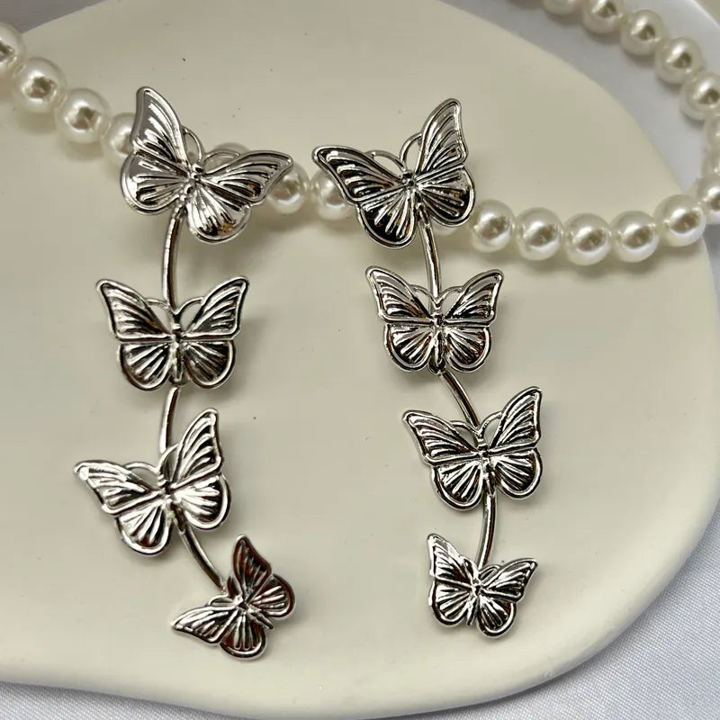 Pierced 3" silver butterfly dangle earrings