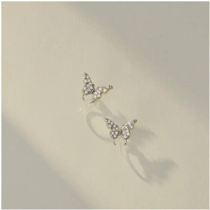 Clip on 1/2" xsmall clear stone butterfly earrings w/plastic comfort clasp