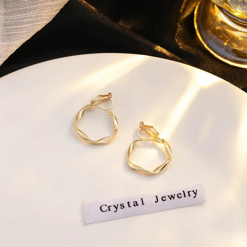 Trendy 1" clip on gold twisted hoop earrings