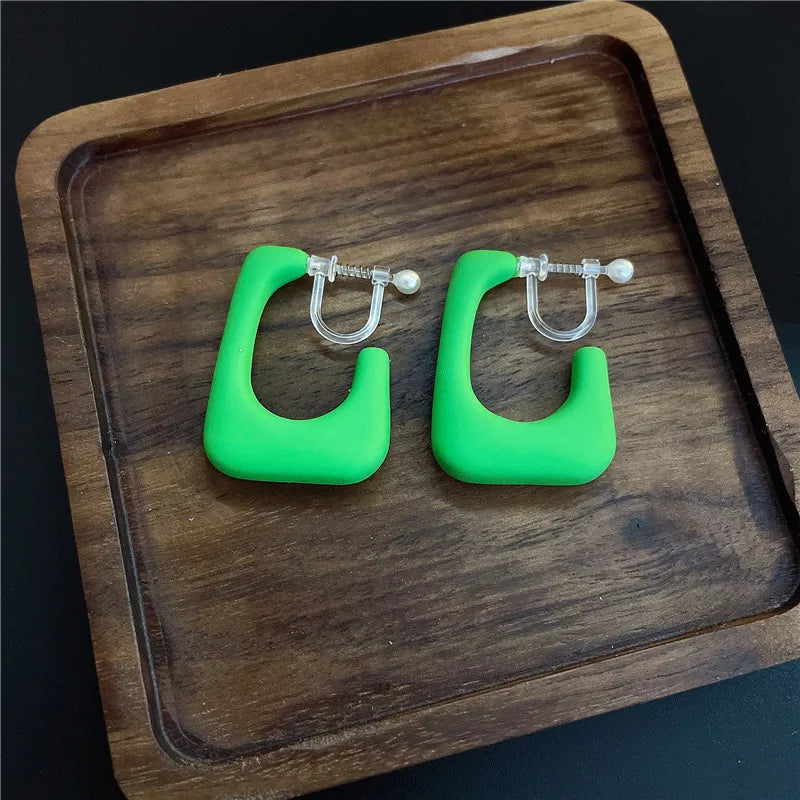 Clip on 1 1/4" small plastic open back earrings in a variety of colors