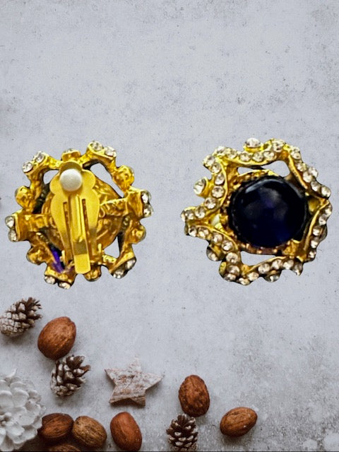 Vintage 1 1/4" gold and clear stone earrings with blue center stone