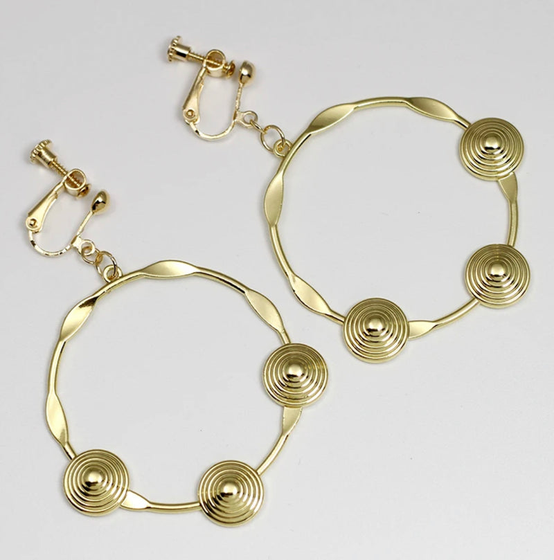 Classy 2 1/4" clip on gold pinched hoop earrings with raised indented circles