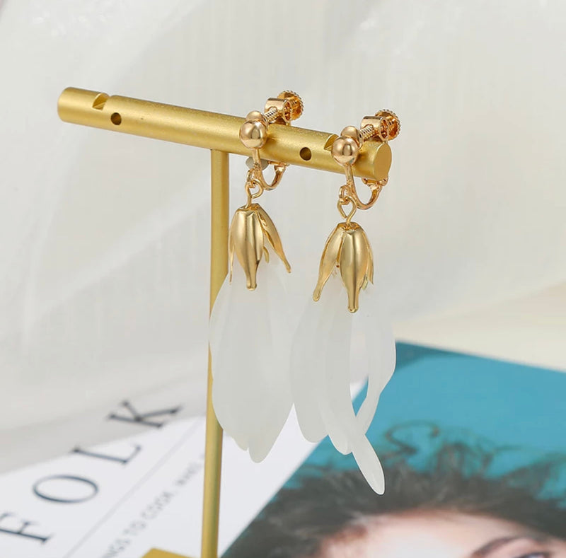 Clip on 2 1/4" gold and white crowned flowing dangle earrings