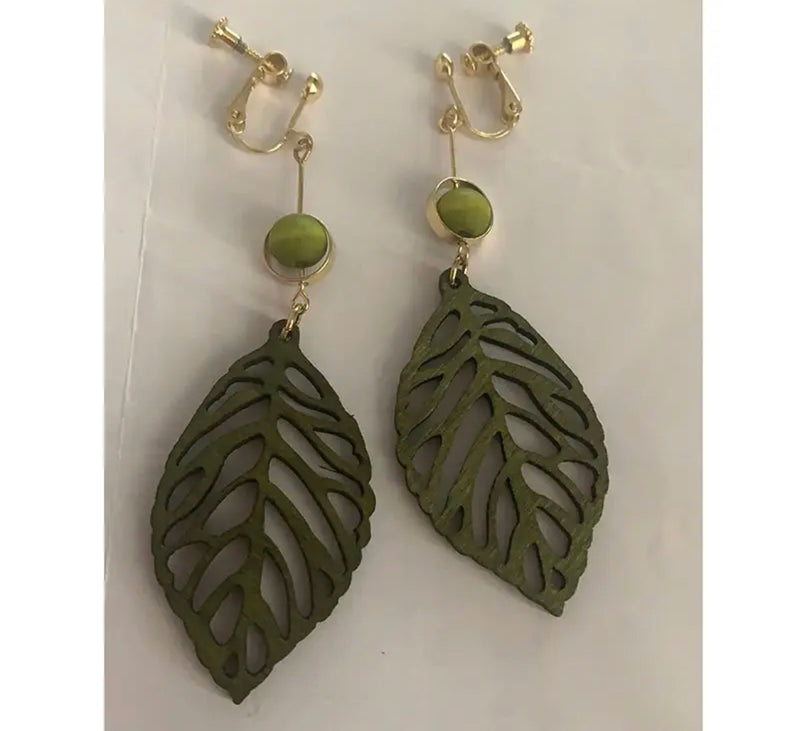 Clip on 3 1/2" gold wire and green wood bead and leaf dangle earrings