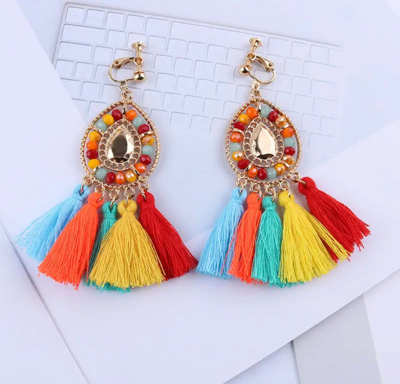 Clip on 3 1/4" gold earrings with beads and tassels in a variety of colors