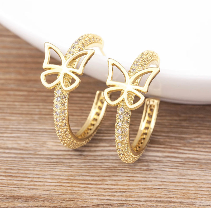 Trendy pierced 1 1/4" gold and clear stone open back butterfly hoop earrings