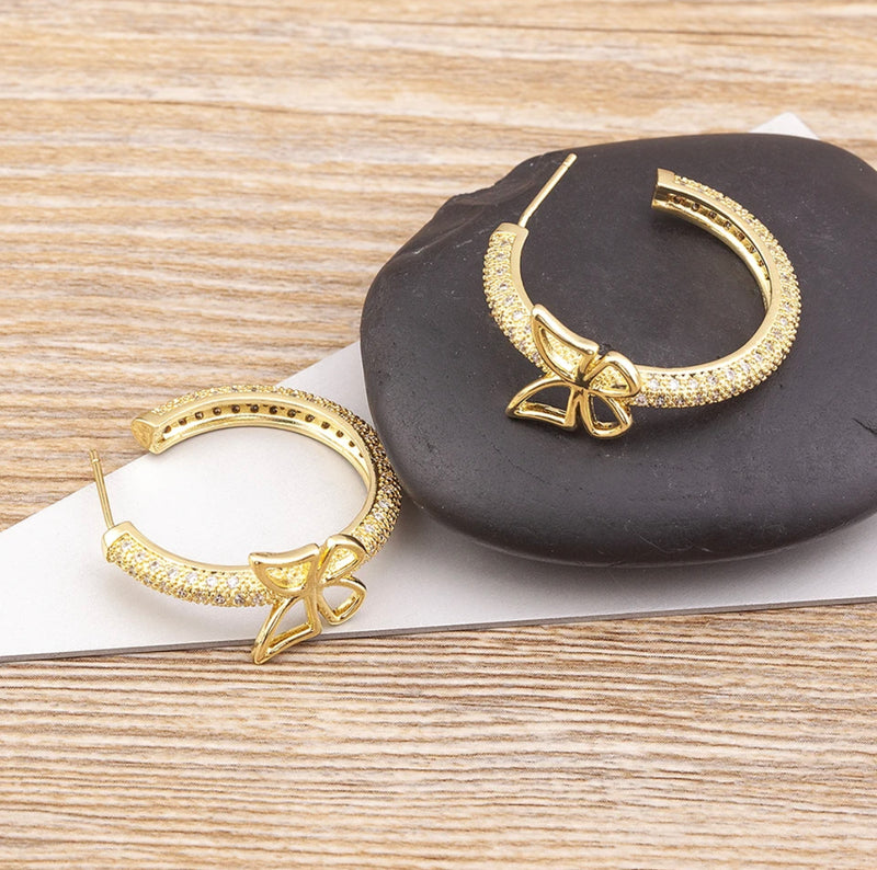 Trendy pierced 1 1/4" gold and clear stone open back butterfly hoop earrings