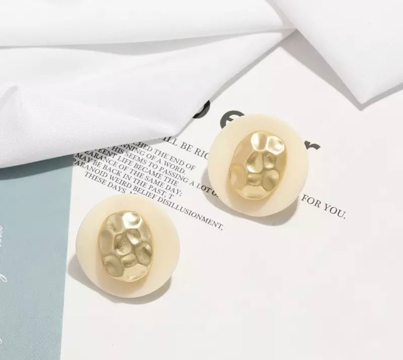 Clip on matte gold wavy white button style earrings