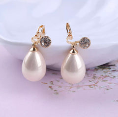 Clip on gold and shiny white dangle teardrop bead earrings