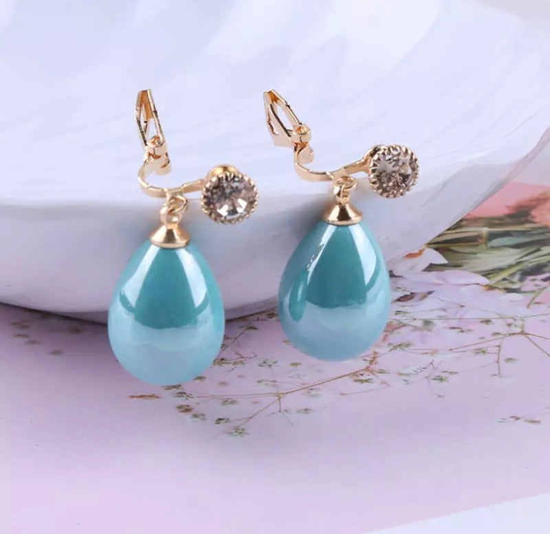 Clip on gold and shiny blue dangle teardrop bead earrings