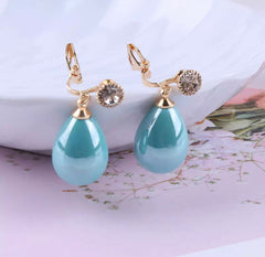 Clip on gold and shiny blue dangle teardrop bead earrings