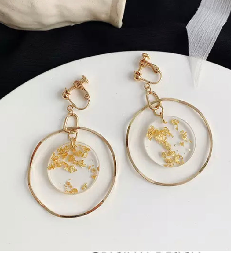 Clip on gold and glitter circle dangle wavy hoop earrings