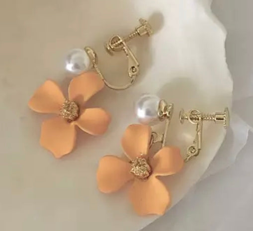 Clip on 1 1/2" gold and orange flower earrings with white pearl