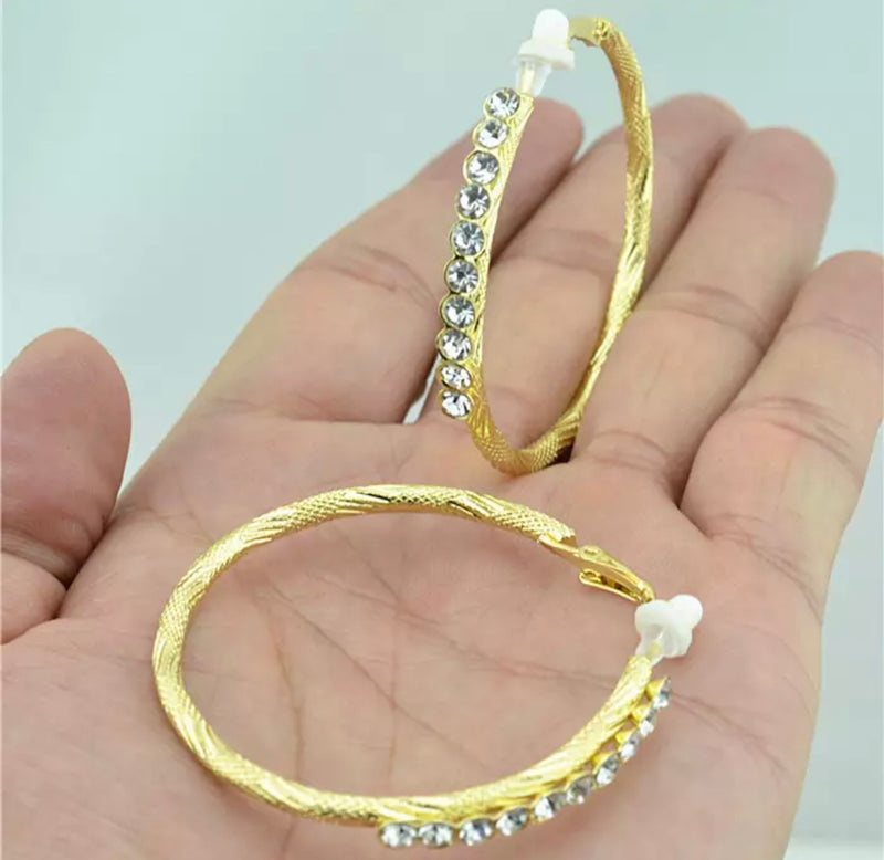 Clip on 2 1/4" textured gold hoop earrings with clear front stones