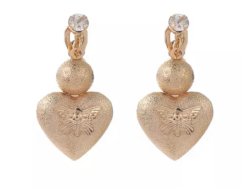 Clip on 1 1/2" gold textured dangle raised heart with butterfly earrings