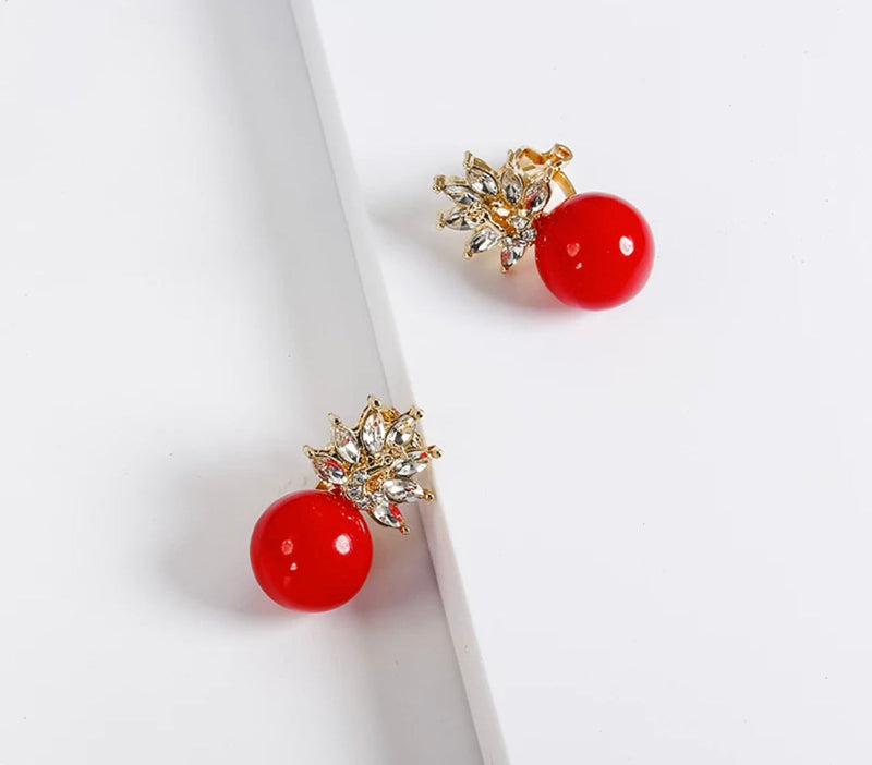 Classy 1" clip on gold clear stone pointed crown red bead earrings