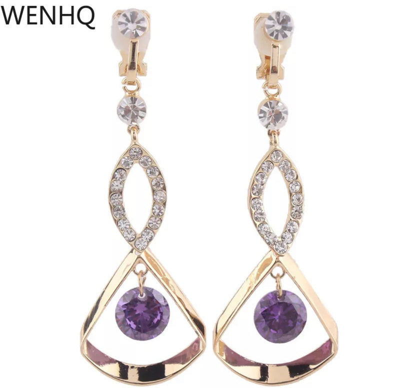 Clip on 2 1/2" long gold, clear and purple dangling stone earrings