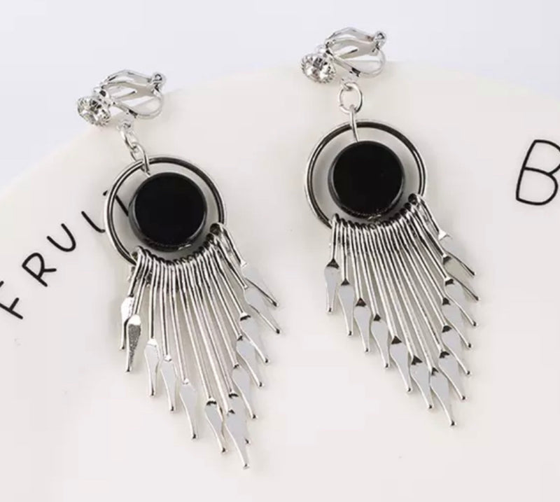 Clip on 2 3/4" shiny silver pointed end dangle earrings with black center bead