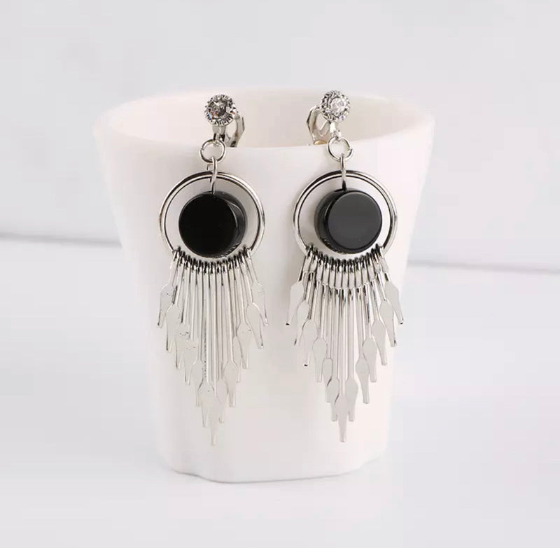 Clip on 2 3/4" shiny silver pointed end dangle earrings with black center bead