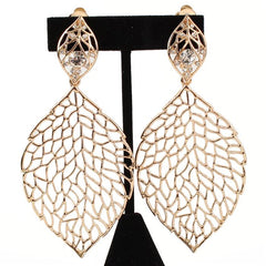 Clip on gold XL cutout leaf earrings with a clear stone