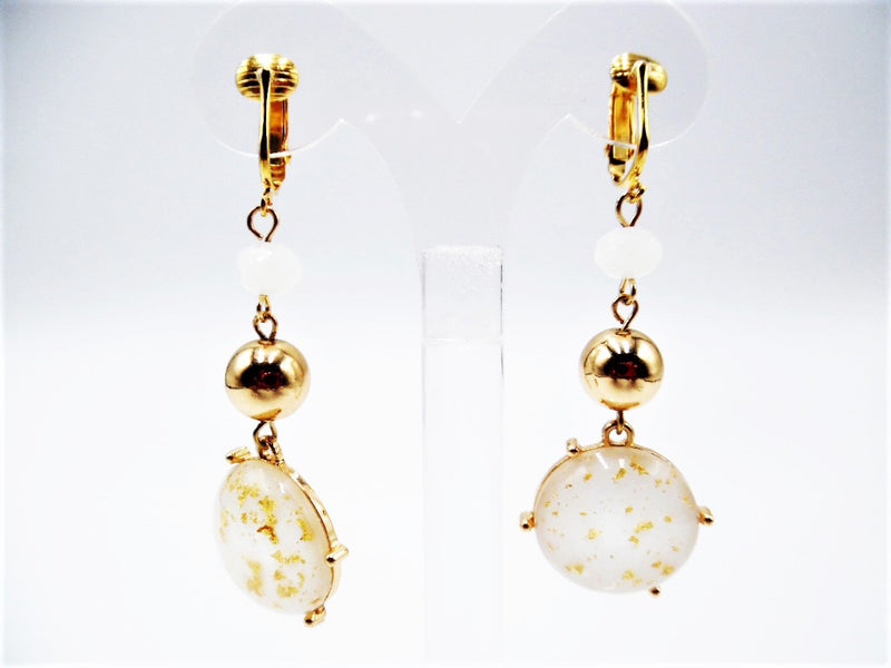 Clip on 2 3/4" white and gold glitter bead dangle earrings