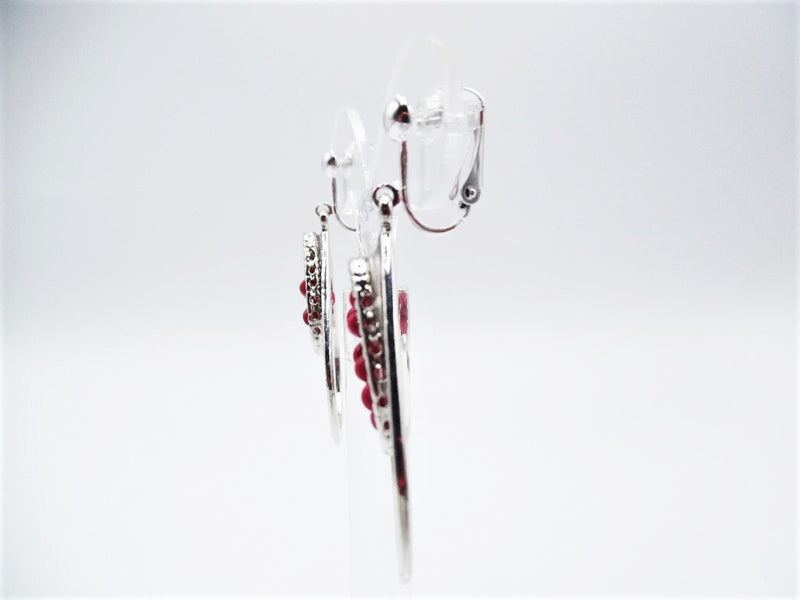 Clip on 2 1/4" silver teardrop dangle earrings with red seed beads in the center