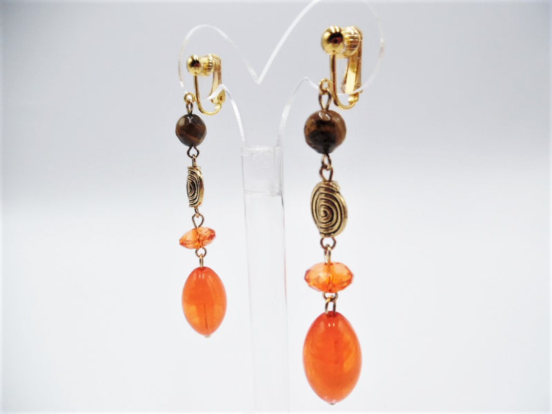Clip on 3 1/4" long gold, brown and orange bead dangle earrings