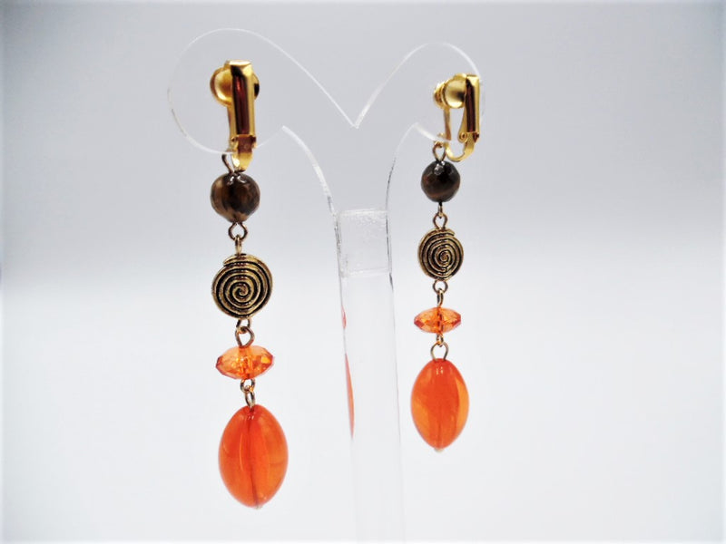 Clip on 3 1/4" long gold, brown and orange bead dangle earrings
