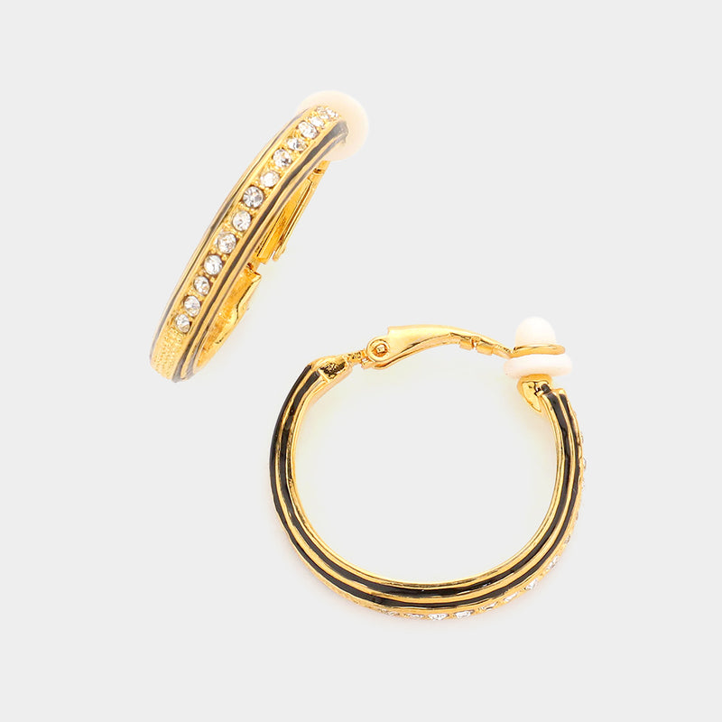 Clip on 1 1/4" gold and black indented hoop earrings with clear stone front
