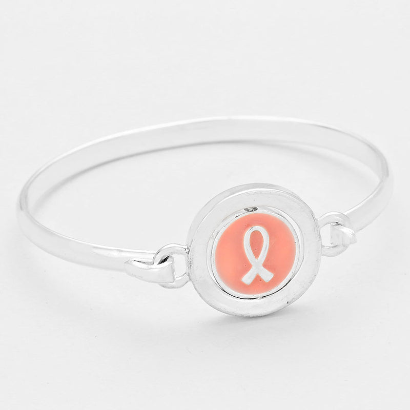 Silver bangle bracelet with rotating pink ribbon "hope"