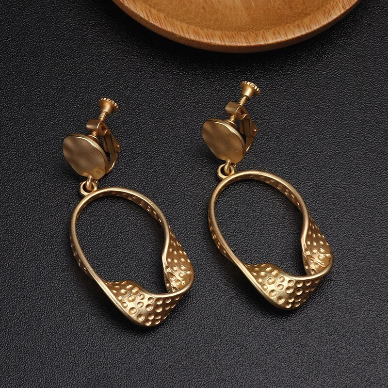 Clip on 2 3/4"  matte gold twisted dangle pinhole hoop earrings