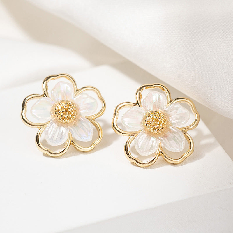 Clip on 3/4" gold and fluorescent white cutout flower earrings