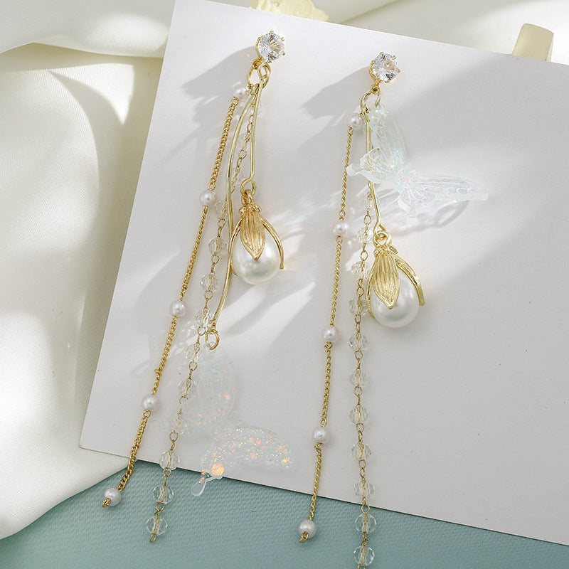 Clip on 4 3/4" gold high and low fluorescent glitter butterfly and pearl earrings