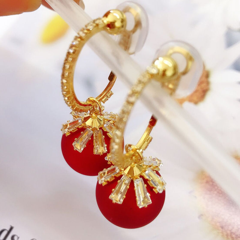 Clip on 1 1/4" gold and red reindeer bell dangle earrings with clear stone