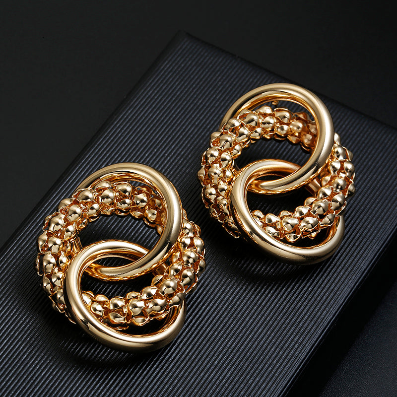 Clip on large textured loose knot shiny gold earrings