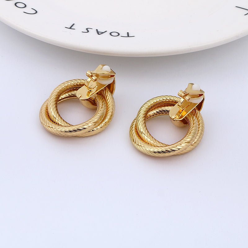 Clip on 1 1/2" gold textured loose knot button style earrings
