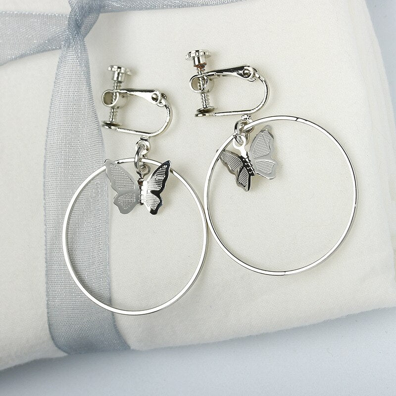 Clip on 2" silver hoop earrings with center butterfly
